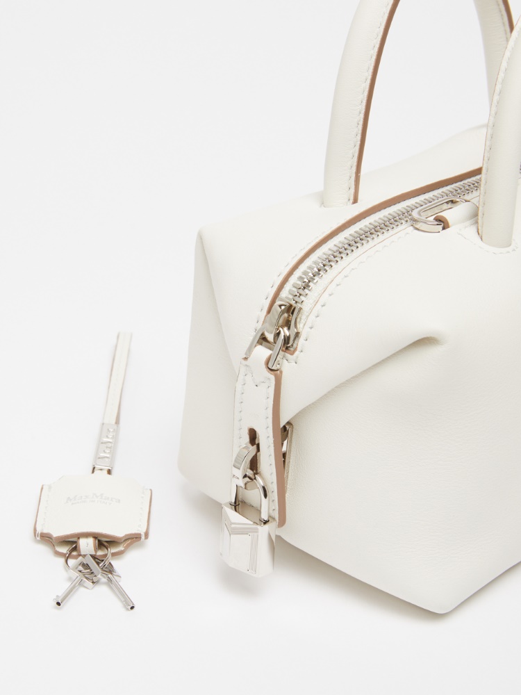 Small leather satchel bag with suede pocket detail, white