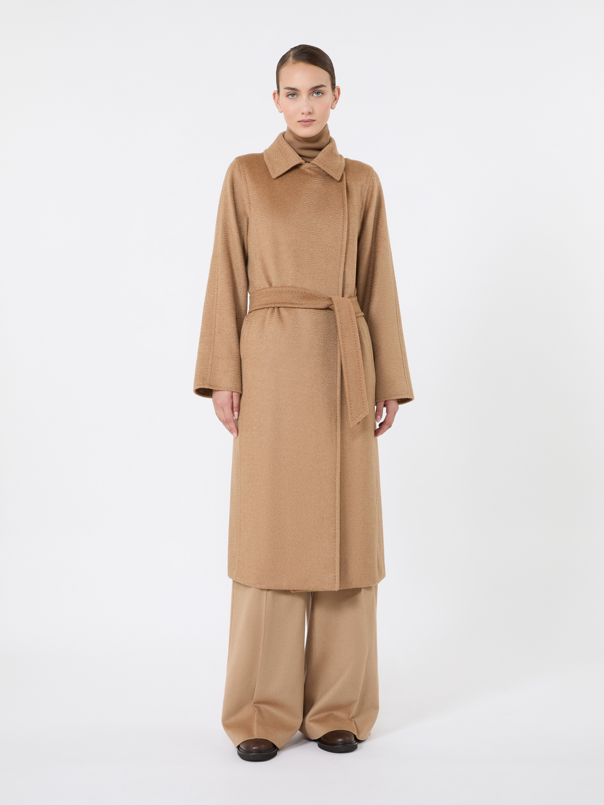 Model wearing the belted Max Mara Manuela Icon Coat in camel