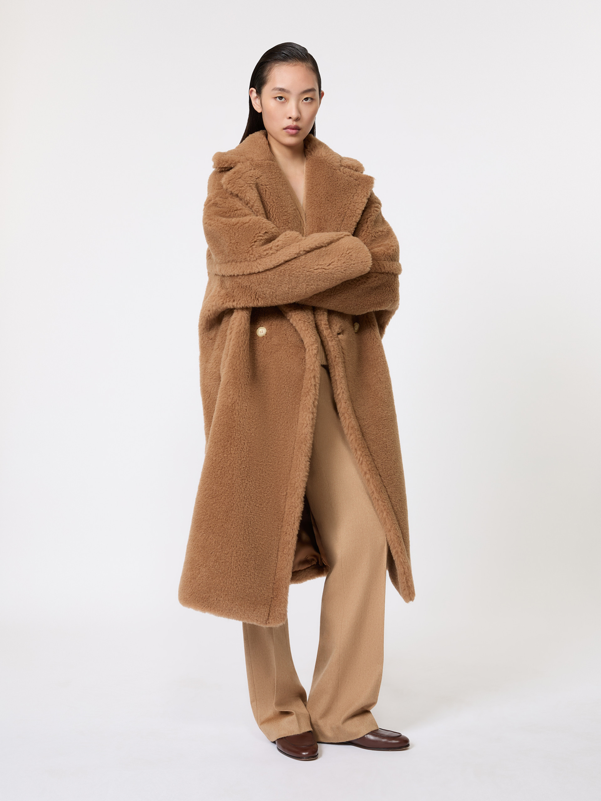Model in the Max Mara Teddy Bear Icon Coat in camel with matching trousers